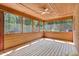 Relaxing screened porch with wood plank flooring and ceilings offers a delightful outdoor space at 105 Hobson Pl, Louisburg, NC 27549