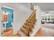 Carpeted staircase features wooden railing and leads to the second floor at 105 Hobson Pl, Louisburg, NC 27549