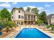 Incredible backyard oasis featuring a sparkling pool, an outdoor kitchen and an ample lounging space at 11 Swallow Tail Ct, Pittsboro, NC 27312