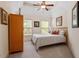 Bedroom featuring a queen bed, neutral walls, carpet flooring, a vaulted ceiling, and two bright windows at 11 Swallow Tail Ct, Pittsboro, NC 27312