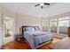 Main bedroom with natural light, ensuite bathroom, and a tray ceiling at 11 Swallow Tail Ct, Pittsboro, NC 27312