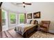 Bedroom featuring a queen bed, hardwood floors, large windows, neutral walls and a vaulted ceiling at 11 Swallow Tail Ct, Pittsboro, NC 27312