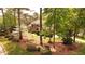 Stately home nestled among trees with manicured landscape and circular driveway at 11 Swallow Tail Ct, Pittsboro, NC 27312