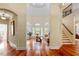 Elegant foyer with hardwood floors and staircase, bathed in natural light at 11 Swallow Tail Ct, Pittsboro, NC 27312