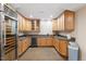 Well-equipped kitchenette with wine fridges, custom cabinetry, and granite countertops for entertaining at 11 Swallow Tail Ct, Pittsboro, NC 27312