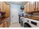 Bright laundry room with washer, dryer, wood countertops, custom backsplash, and ample storage at 11 Swallow Tail Ct, Pittsboro, NC 27312