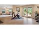 Open living area with exercise equipment, comfortable seating, and access to the outdoor patio at 11 Swallow Tail Ct, Pittsboro, NC 27312