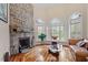 Bright living room with stone fireplace and hardwood floors at 11 Swallow Tail Ct, Pittsboro, NC 27312