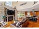 Open concept living area with stone fireplace and kitchen view at 11 Swallow Tail Ct, Pittsboro, NC 27312