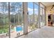 Sunroom with large windows overlooking the outdoor pool and yard at 11 Swallow Tail Ct, Pittsboro, NC 27312