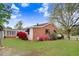 Cozy home with brick and siding, complemented by a screened-in porch and vibrant flowers at 1149 Us-701 Hwy, Four Oaks, NC 27524