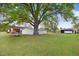 Spacious backyard featuring mature trees and outbuildings at 1149 Us-701 Hwy, Four Oaks, NC 27524