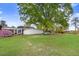 Large backyard with a screened-in porch, outbuildings, and a lush green lawn at 1149 Us-701 Hwy, Four Oaks, NC 27524