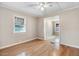 Sunlit bedroom featuring hardwood floors, ceiling fan, and neutral paint at 1149 Us-701 Hwy, Four Oaks, NC 27524