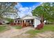 Traditional single-story house with a carport, brick accents, and blossoming shrubs at 1149 Us-701 Hwy, Four Oaks, NC 27524