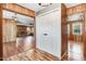 Hallway with hardwood floors, white closet, and views into living and dining rooms at 1149 Us-701 Hwy, Four Oaks, NC 27524