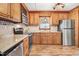 Traditional kitchen featuring wood cabinets, stainless steel appliances and granite countertops at 1149 Us-701 Hwy, Four Oaks, NC 27524