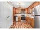 Efficient kitchen featuring stainless steel appliances, wood cabinetry, and wood look floors at 1149 Us-701 Hwy, Four Oaks, NC 27524