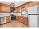 Well-lit kitchen featuring stainless steel appliances, wooden cabinets, and modern finishes at 1149 Us-701 Hwy, Four Oaks, NC 27524