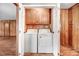 Dedicated laundry area with washer, dryer, and built-in storage cabinets for supplies at 1149 Us-701 Hwy, Four Oaks, NC 27524