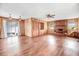 Open living room with a brick fireplace, hardwood floors, and natural light from large windows at 1149 Us-701 Hwy, Four Oaks, NC 27524