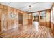 Spacious living room featuring wood paneling, unique light fixture, and hardwood floors at 1149 Us-701 Hwy, Four Oaks, NC 27524