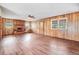 Large living room features a brick fireplace, hardwood floors, and paneled walls at 1149 Us-701 Hwy, Four Oaks, NC 27524