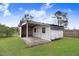 Exterior of outbuilding with porch-style lean-to with wood support beams on a large grassy lawn at 1149 Us-701 Hwy, Four Oaks, NC 27524
