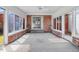 Bright sunroom with brick accents, multiple windows, and a ceiling fan at 1149 Us-701 Hwy, Four Oaks, NC 27524