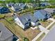 Aerial view of a two story home with a dark gray roof, lush lawn, and mature trees at 1165 Saint Cloud Loop, Apex, NC 27523