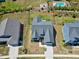 Stunning aerial view of a modern home with a well-manicured lawn, stylish roof, and community pool at 1165 Saint Cloud Loop, Apex, NC 27523