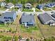 Expansive aerial view of a home featuring a well-maintained lawn, fenced backyard, and covered back porch at 1165 Saint Cloud Loop, Apex, NC 27523