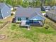 A lush backyard featuring a covered deck, perfect for outdoor relaxation and entertaining in a fenced yard at 1165 Saint Cloud Loop, Apex, NC 27523