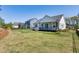 Private backyard with grass, view of the deck and fenced perimeter of the property at 1165 Saint Cloud Loop, Apex, NC 27523