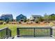 View from the back deck looking out over a well-manicured lawn and the surrounding community at 1165 Saint Cloud Loop, Apex, NC 27523