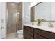 Modern bathroom features a double sink vanity with sleek countertops, vanity, and a glass shower at 1165 Saint Cloud Loop, Apex, NC 27523