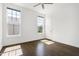 Light-filled bedroom features dark wood floors and sunny windows overlooking the landscaped yard at 1165 Saint Cloud Loop, Apex, NC 27523