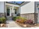 Inviting front porch with stone accents, landscaping, and a stylish front door at 1165 Saint Cloud Loop, Apex, NC 27523