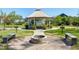 Community gazebo with white supports and a table and seating, adjacent to a fire pit at 1165 Saint Cloud Loop, Apex, NC 27523
