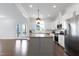 Bright and airy kitchen featuring an island, white cabinets, and stainless steel appliances at 1165 Saint Cloud Loop, Apex, NC 27523