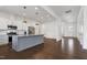 Modern kitchen with a center island, stainless steel appliances, and dark hardwood floors at 1165 Saint Cloud Loop, Apex, NC 27523