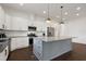 Beautiful kitchen with a large island, stainless steel appliances, and elegant white cabinetry at 1165 Saint Cloud Loop, Apex, NC 27523