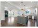 Open-concept kitchen featuring a large island, stainless steel appliances, and bright, white cabinetry at 1165 Saint Cloud Loop, Apex, NC 27523
