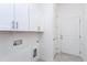 Well-lit laundry room with white cabinets, tile floor and convenient utility connections at 1165 Saint Cloud Loop, Apex, NC 27523