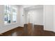 Bright living room with hardwood floors, a window, and a doorway leading to another room at 1165 Saint Cloud Loop, Apex, NC 27523