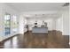 Open-concept living space leading to the modern kitchen with a gray island and stainless appliances at 1165 Saint Cloud Loop, Apex, NC 27523