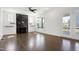 Bright living room with a modern fireplace, hardwood floors, and access to the outdoor patio at 1165 Saint Cloud Loop, Apex, NC 27523