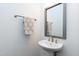 Elegant powder room featuring a pedestal sink, modern fixtures, and a decorative mirror at 1165 Saint Cloud Loop, Apex, NC 27523