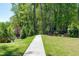 A peaceful walking path surrounded by lush greenery and landscaping in the community at 1165 Saint Cloud Loop, Apex, NC 27523