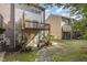 Backyard view featuring a wooden deck and patio area of a gray two-story townhome at 117 Gallent Hedge Trl, Apex, NC 27539